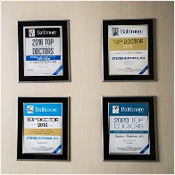 Set of four framed employee recognition plaques with blue and gold designs for workplace awards