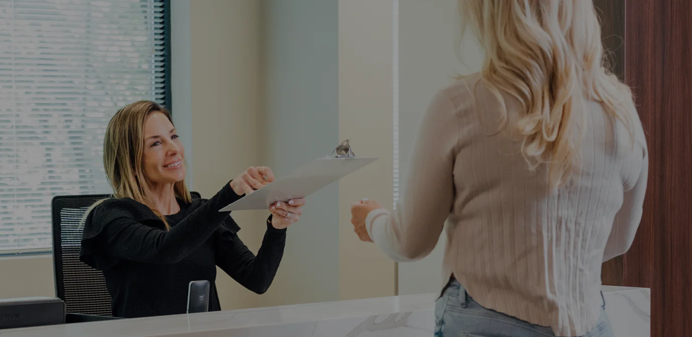 Professional woman at desk consulting with client in modern office setting - in Owings Mills, MD
