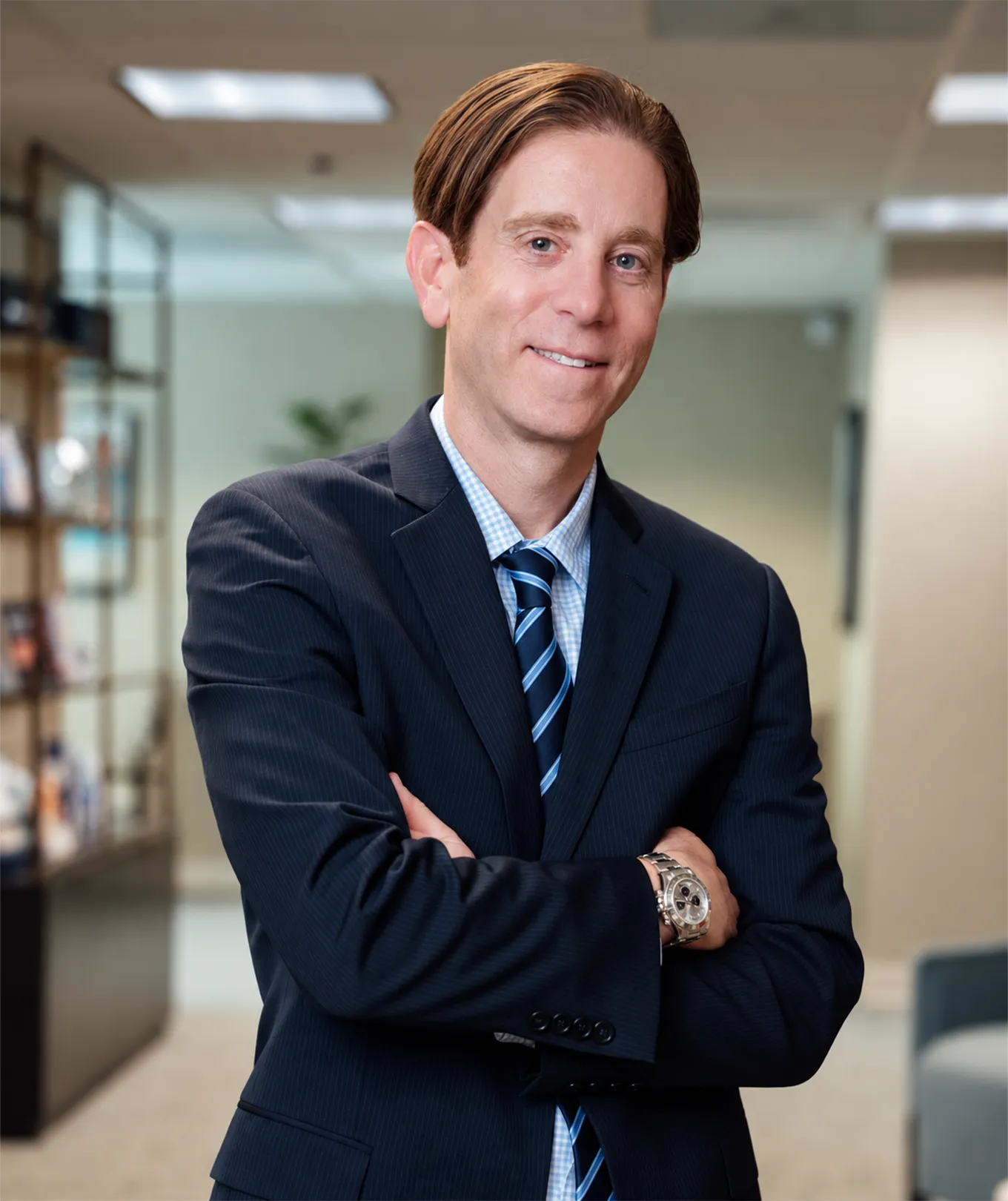 Dr Rottman MD in navy suit and striped tie with arms crossed in medical office setting - in Owings Mills, MD